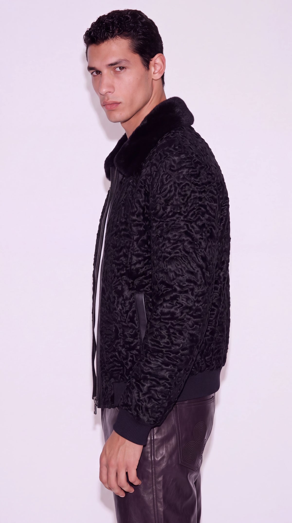 The Noir Westminster black astrakhan bomber jacket by Christopher Noir, side view