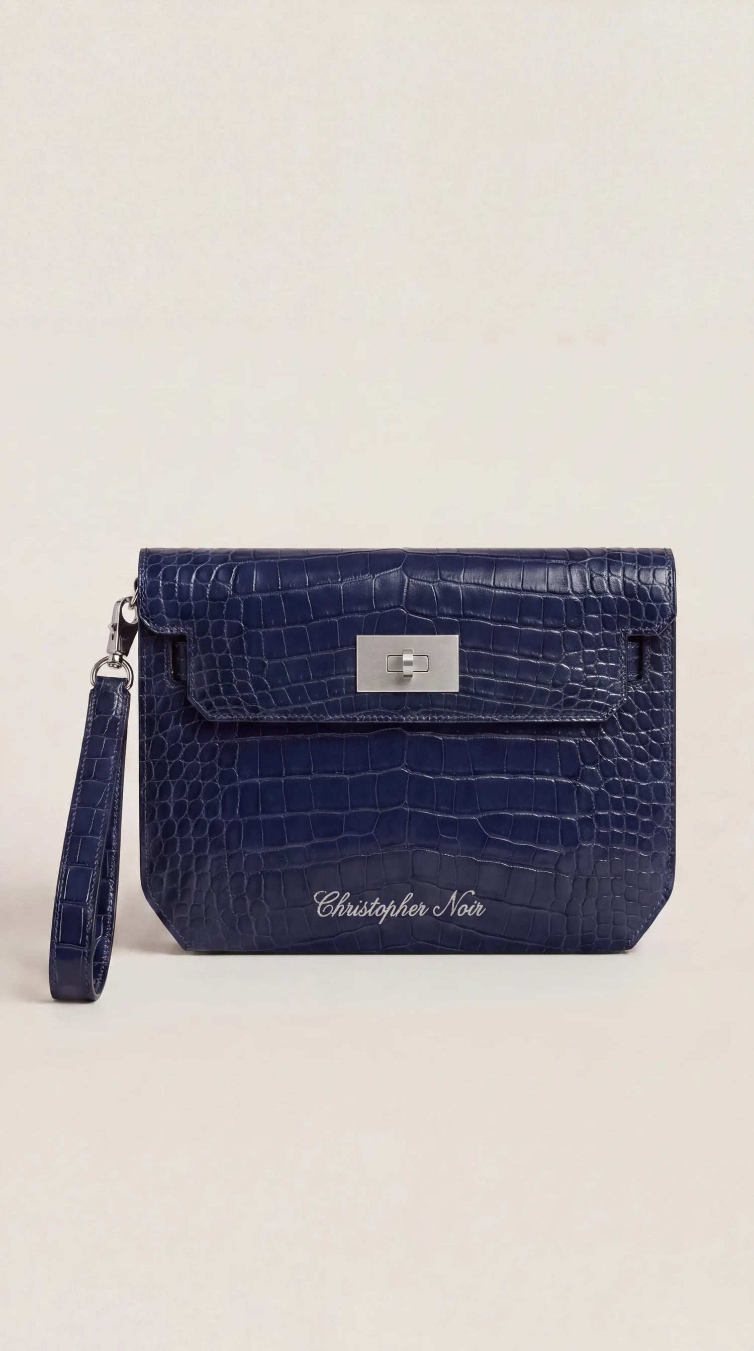 Christopher Noir croc-embossed leather envelope clutch in navy, front view with silver-tone turn-lock and wristlet strap