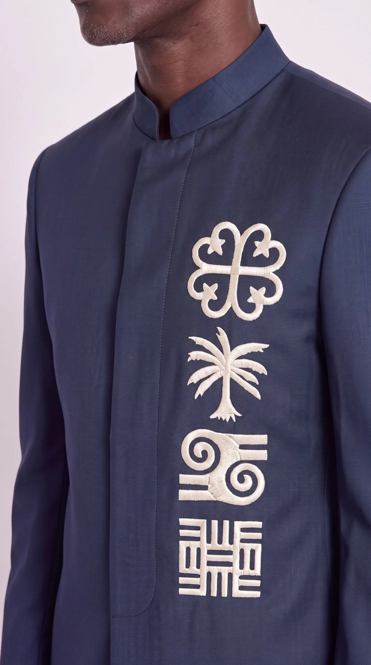 The Noir Adinkra Suit — Navy Embroidered Mandarin Suit — ivory Adinkra-inspired embroidery close-up, Christopher Noir
