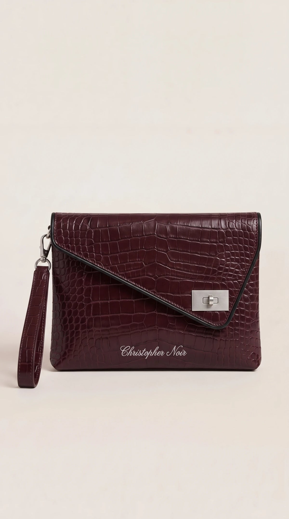 The Noir Aldeburgh burgundy croc-effect leather envelope clutch, front view with contrast black edge piping and silver-tone turn-lock