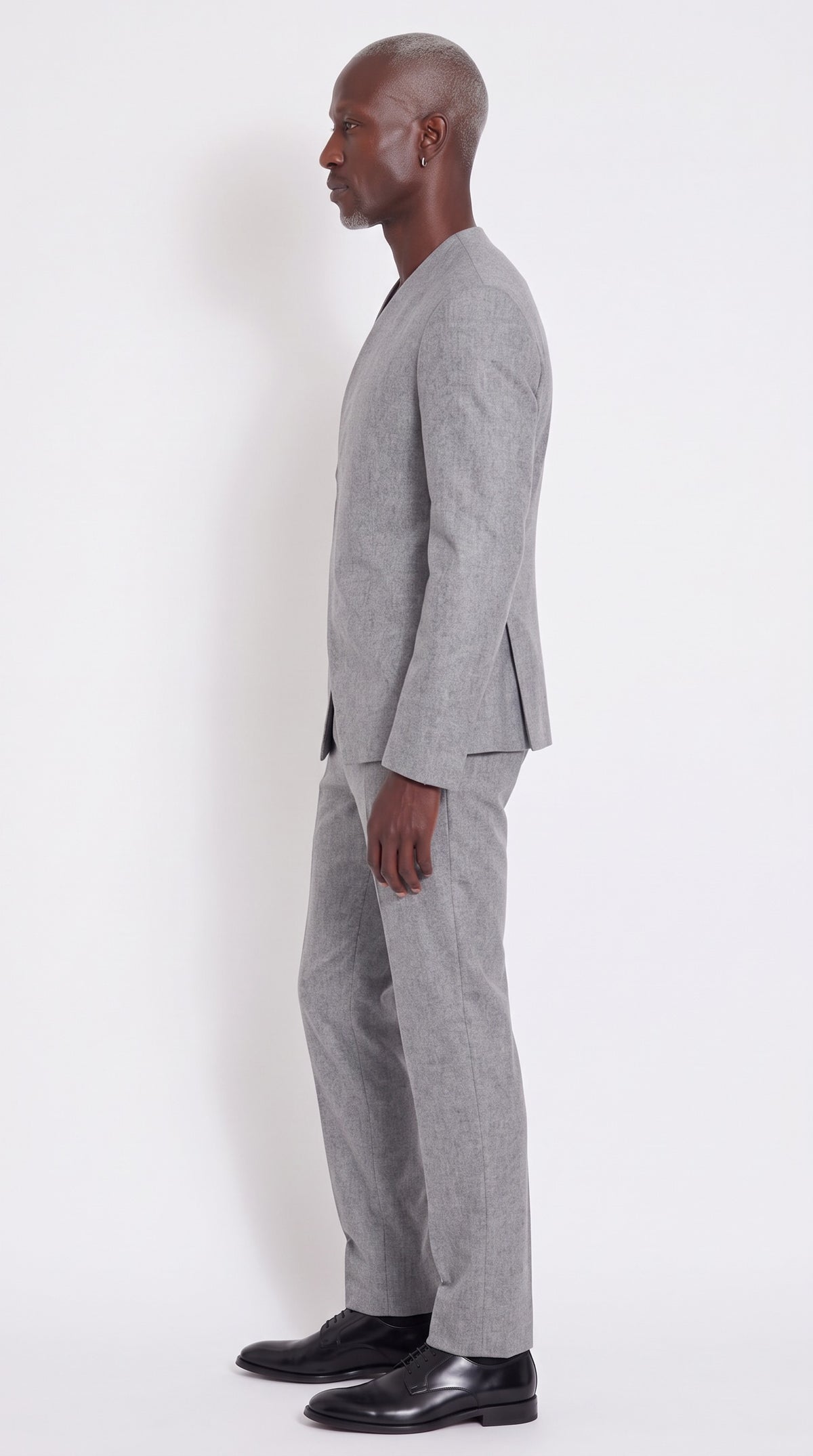 The Noir Ascent Guard Suit — Asymmetric Longline Suit – side profile view, Christopher Noir