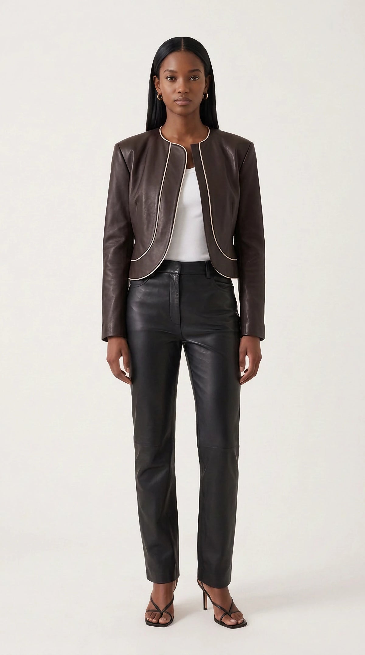 The Noir Bressay collarless espresso leather jacket with curved front panels and contrast cream piping