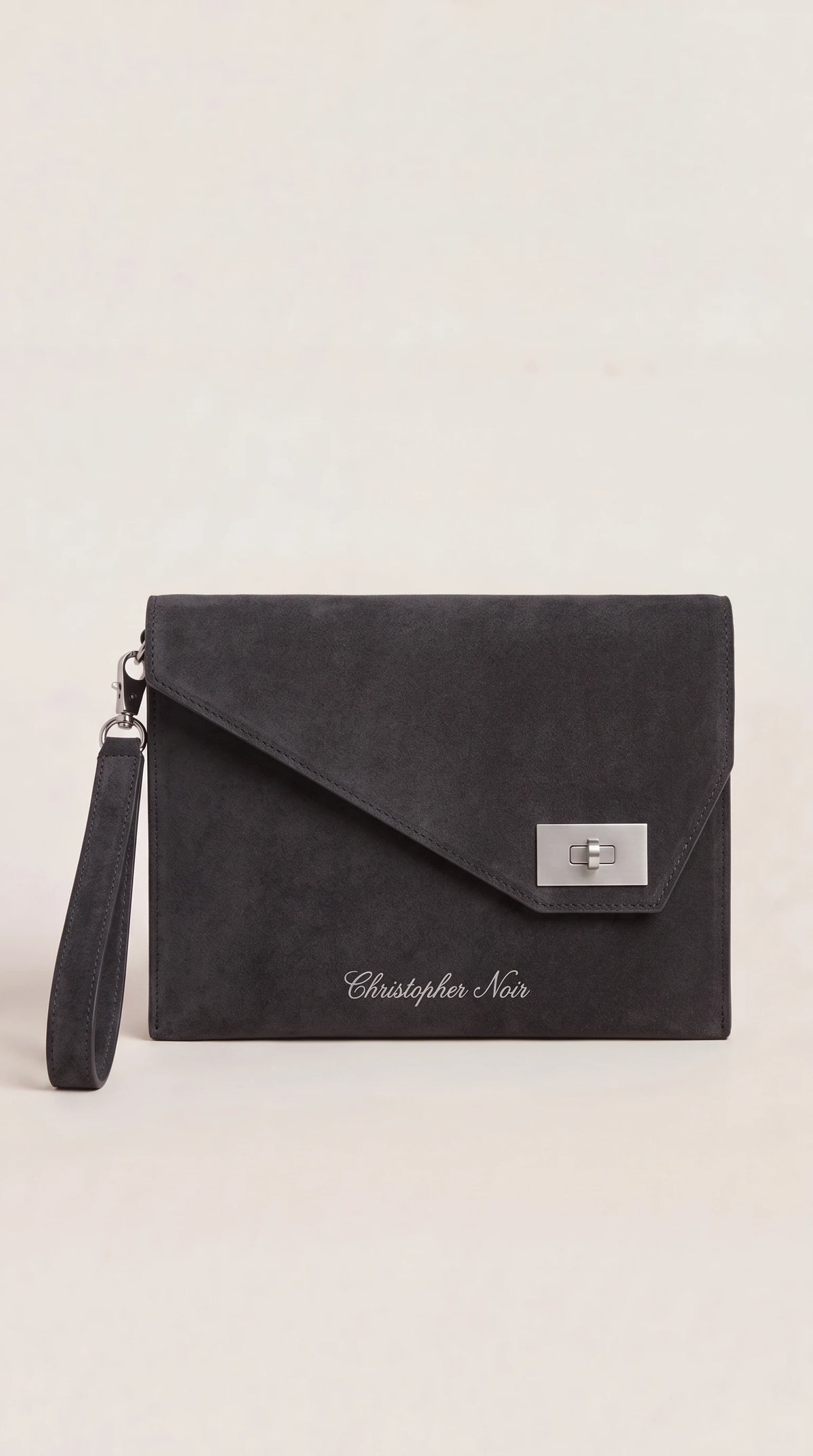 The Noir Corbridge charcoal suede-finish leather envelope clutch, front view with angled point flap and silver-tone turn-lock