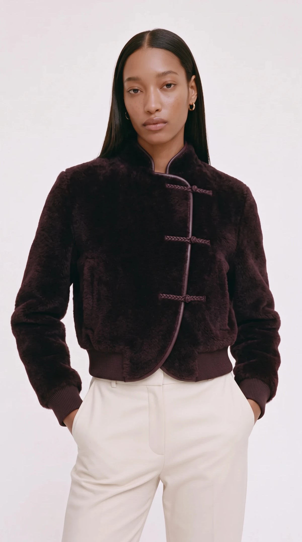 The Noir Fetlar plum shearling bomber with three braided leather frog fastenings and leather-piped curved front