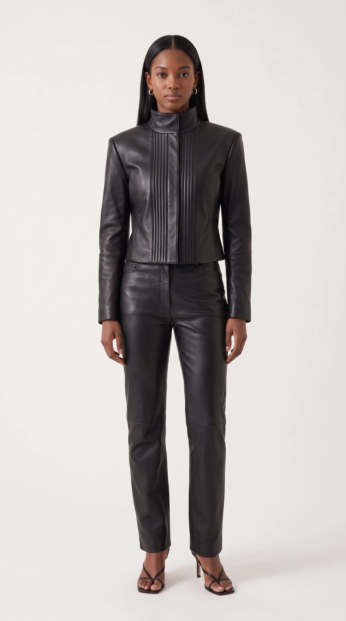 The Noir Flotta cropped black leather jacket with high funnel neck and channel-stitched front panels