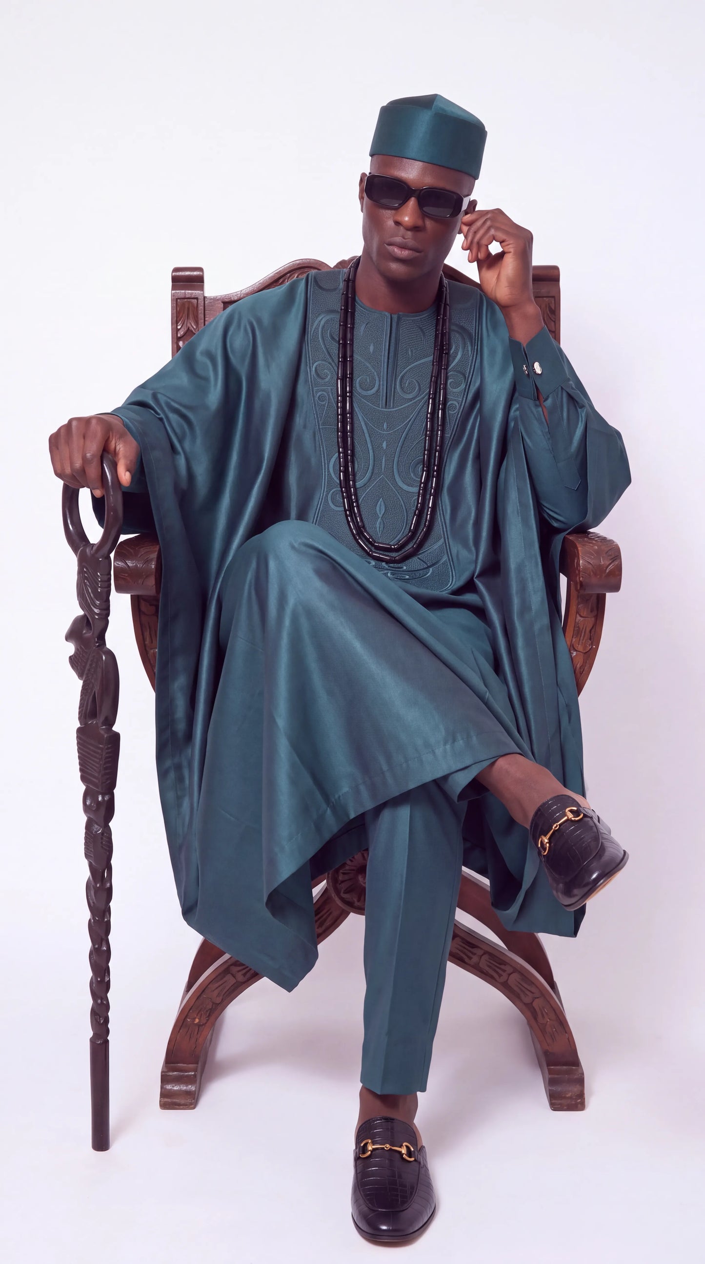 Noir Lagoon Agbada — teal agbada set, seated view