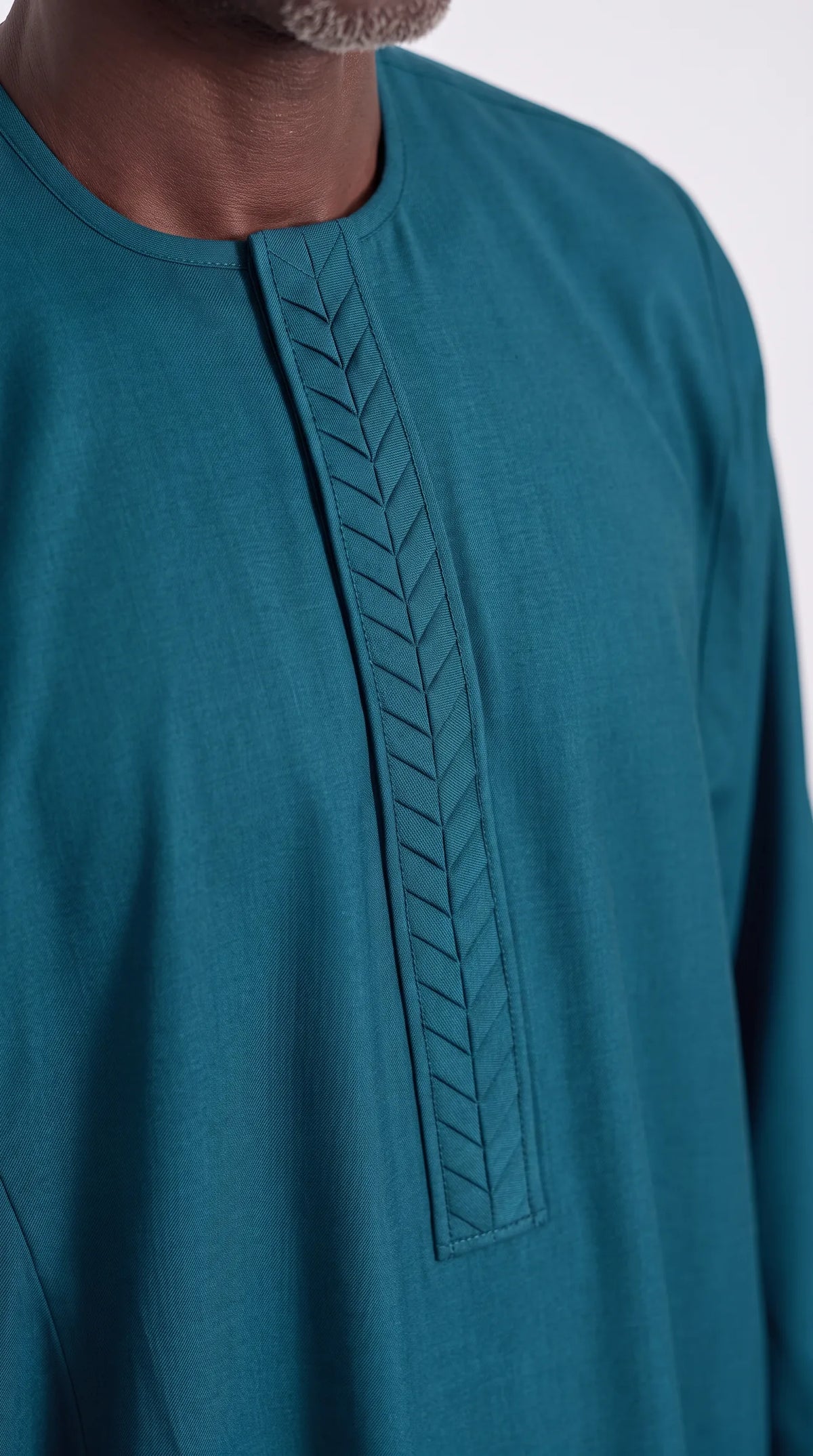Noir Peacock Agbada — deep teal men's agbada set, close-up of the chest detail
