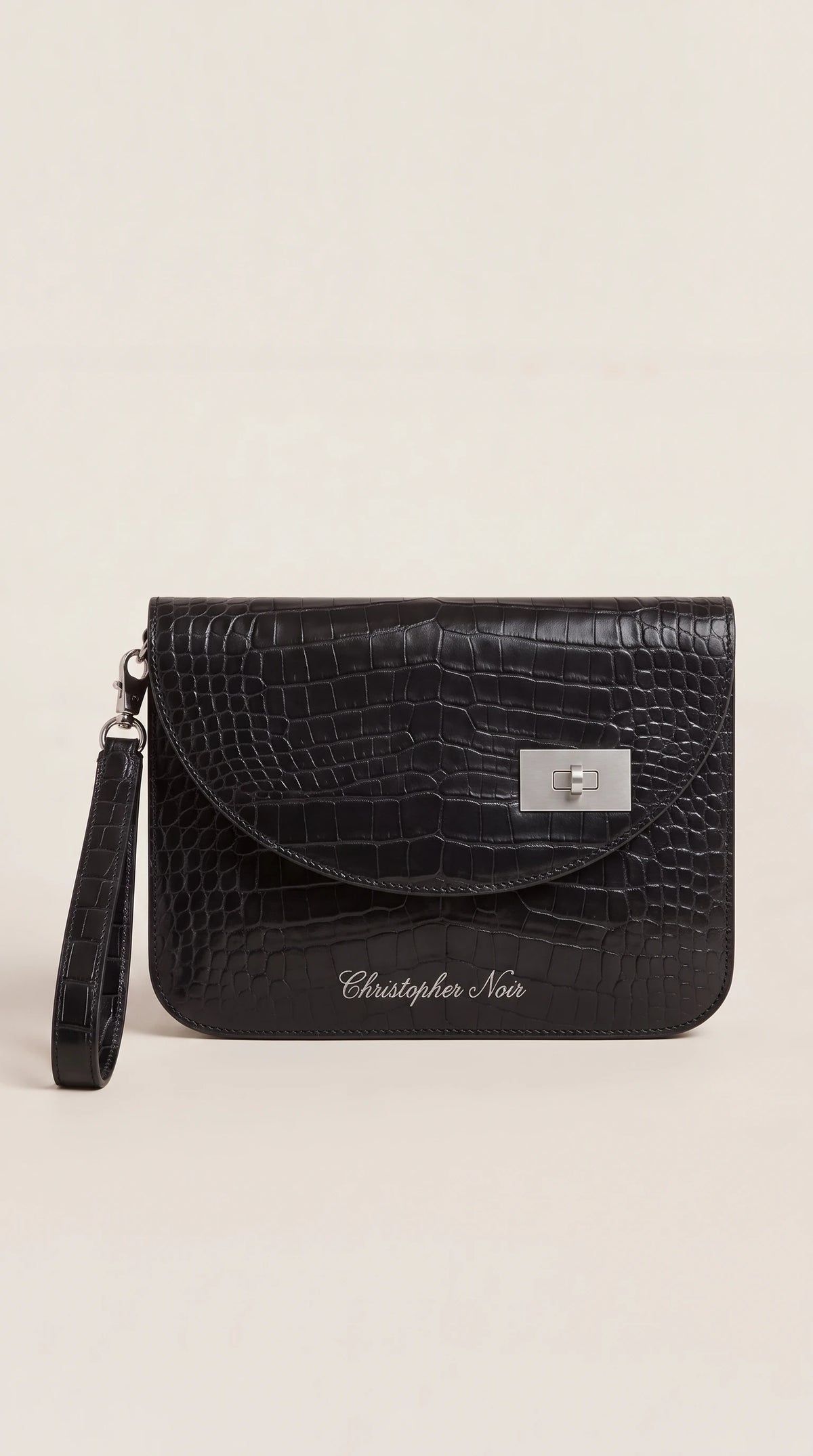 The Noir Thaxted black croc-effect leather wristlet clutch, front view with offset silver-tone turn-lock and detachable wrist strap