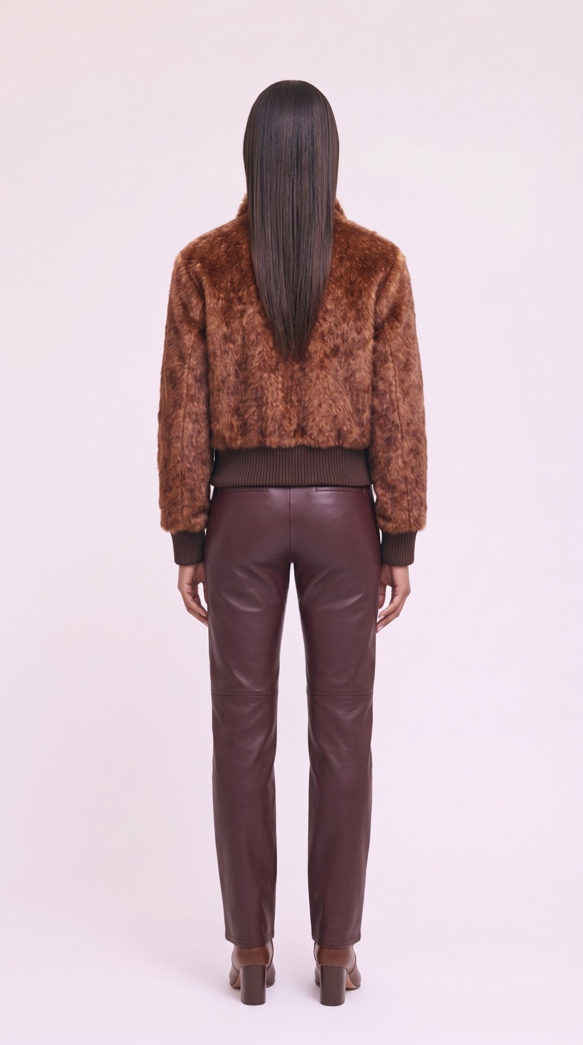 Back view of the rust faux-fur bomber jacket