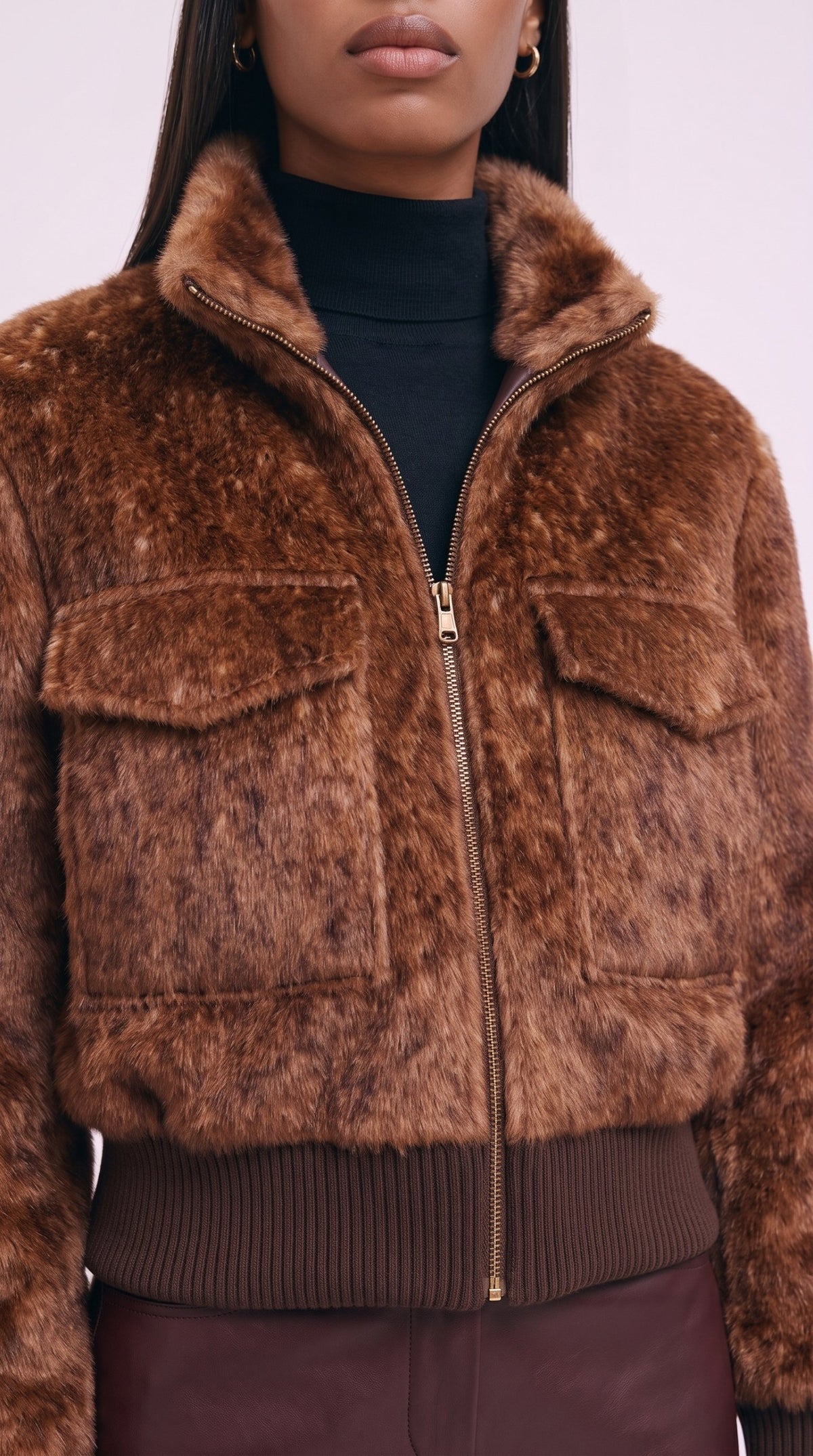 Close-up of the faux-fur texture, flap pockets and gold-tone zip