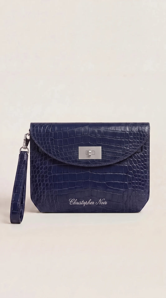 The Noir Wentworth navy croc-effect leather wristlet clutch, front view with silver-tone turn-lock and detachable wrist strap