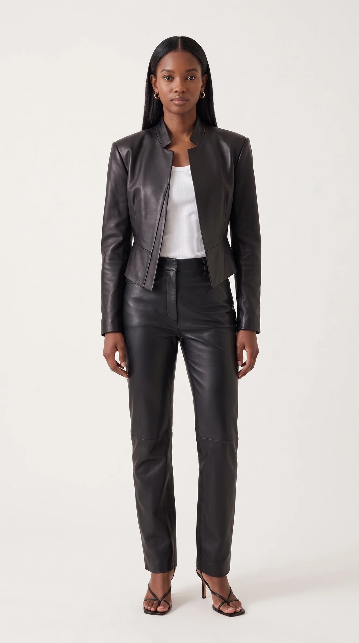 The Noir Whalsay cropped black leather jacket with notched stand collar and pointed peplum hem