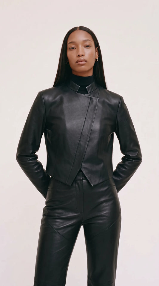 The Noir Wyre cropped black leather jacket with notched stand collar and diagonal wrap front ending in a pointed hem