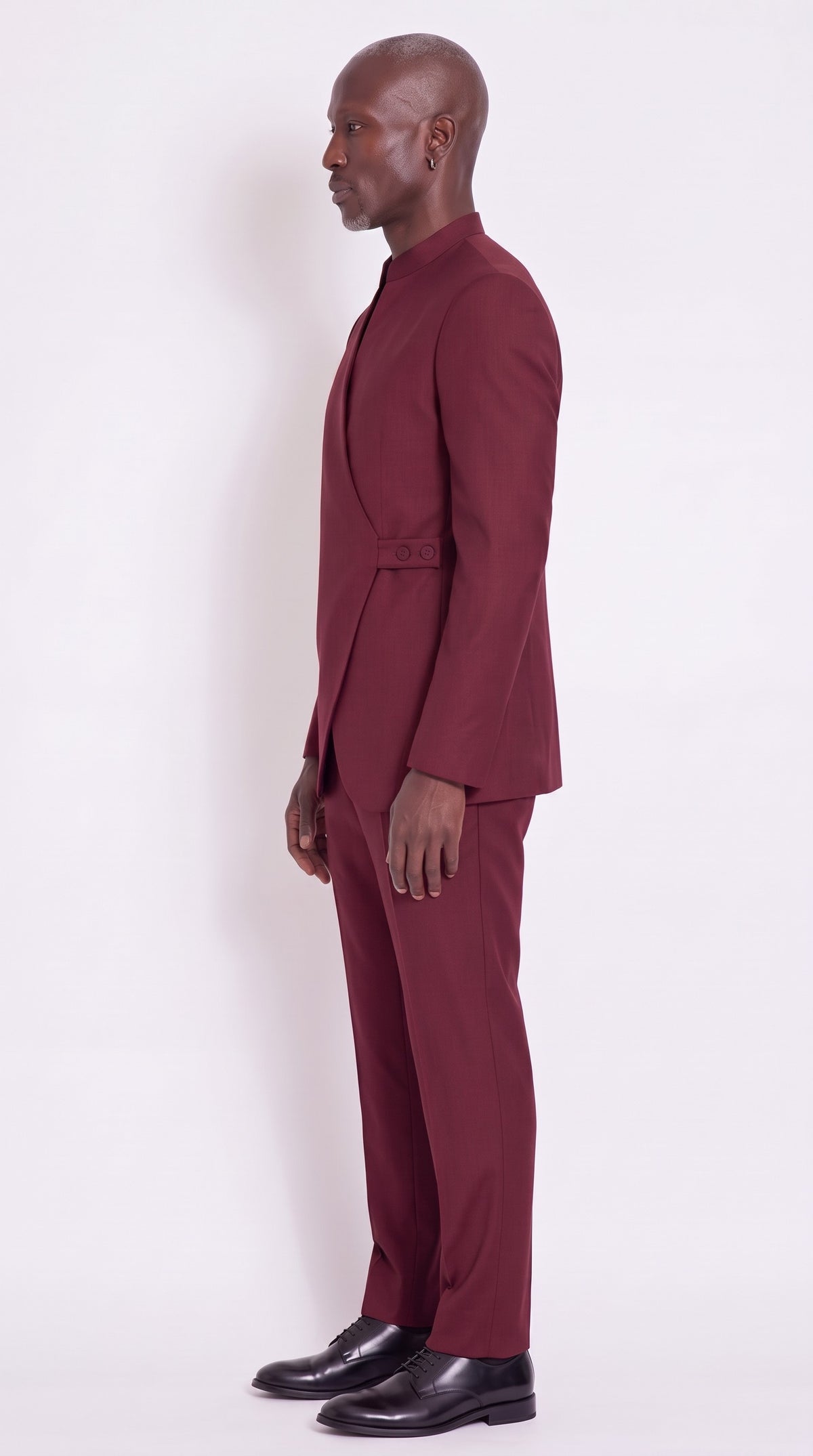 The Noir Crest Suit — Burgundy Tab-Fastened Wrap Suit – side profile view, Christopher Noir