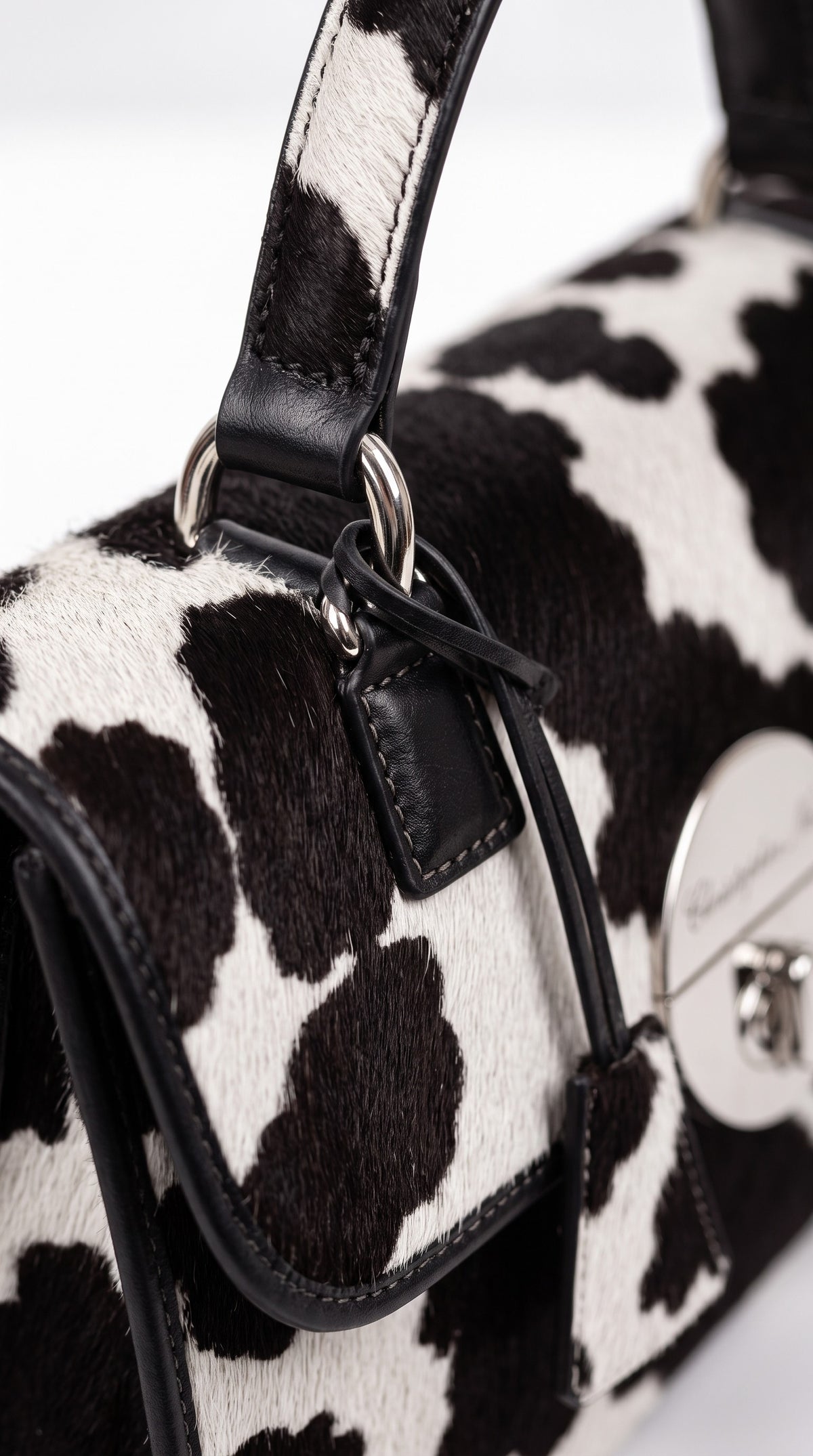 The Noir Malvern — Cow Print Top-Handle Handbag – detail close-up, Christopher Noir